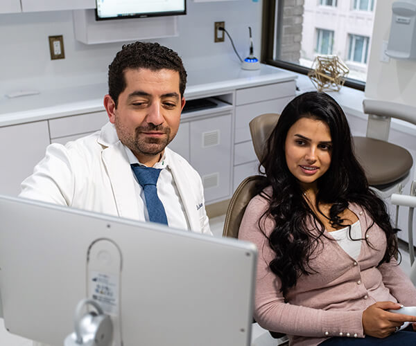 Dr. Husam with a young woman in the consulting room